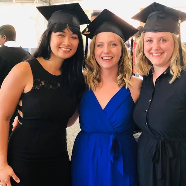 Kelsey with two friends graduating with a Bachelors in Therapeutic Recreation