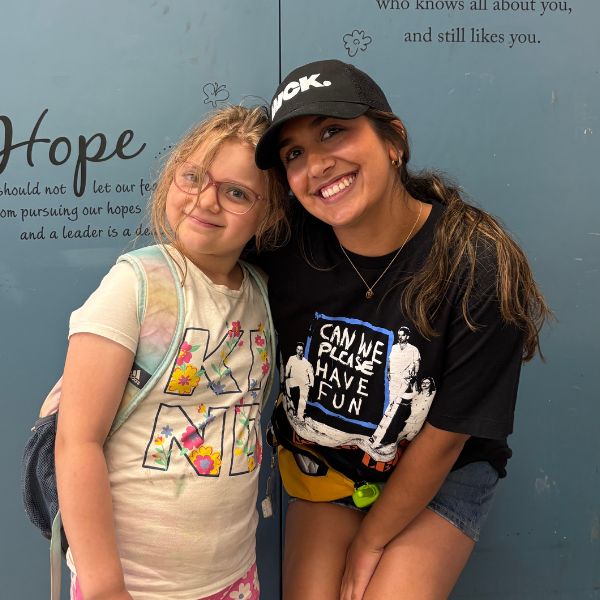 City Camp volunteer and camper smiling at the camera. 