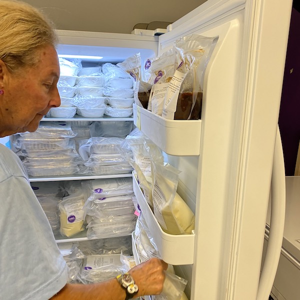 Volunteer Gail is checking the contents of the freezer