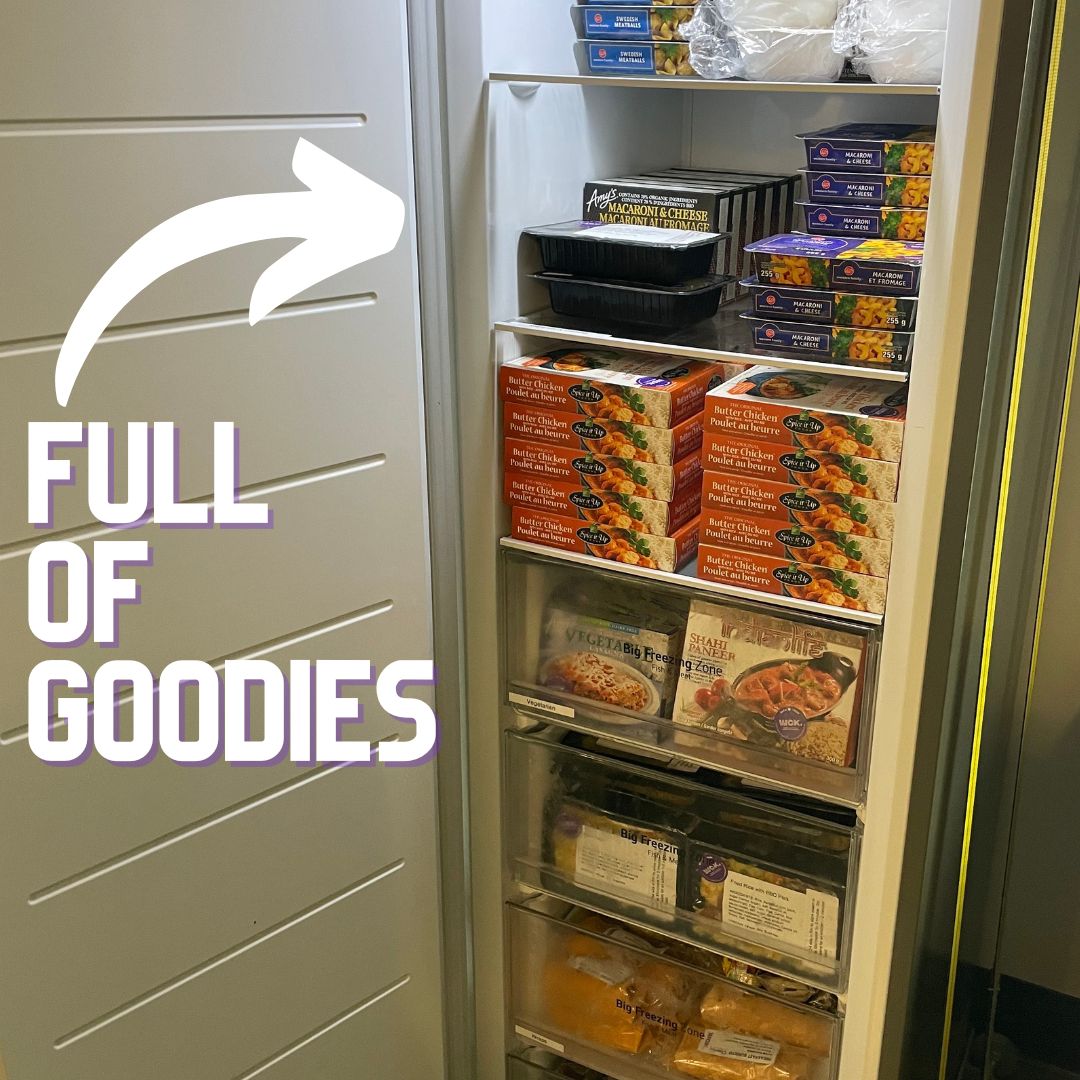 A photo of the WCK freezer in the children's hospital, open, showing it packed with frozen meals. There is a white arrow pointing to the meals with text that reads "Full of goodies."