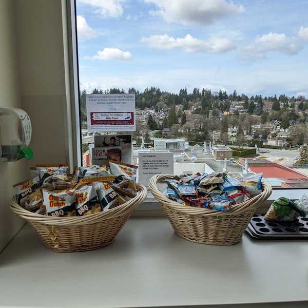 In the family lounge on the T8 ward at Children's Hospital. The photo shows two baskets by the window, full of snacks provided by WCK.